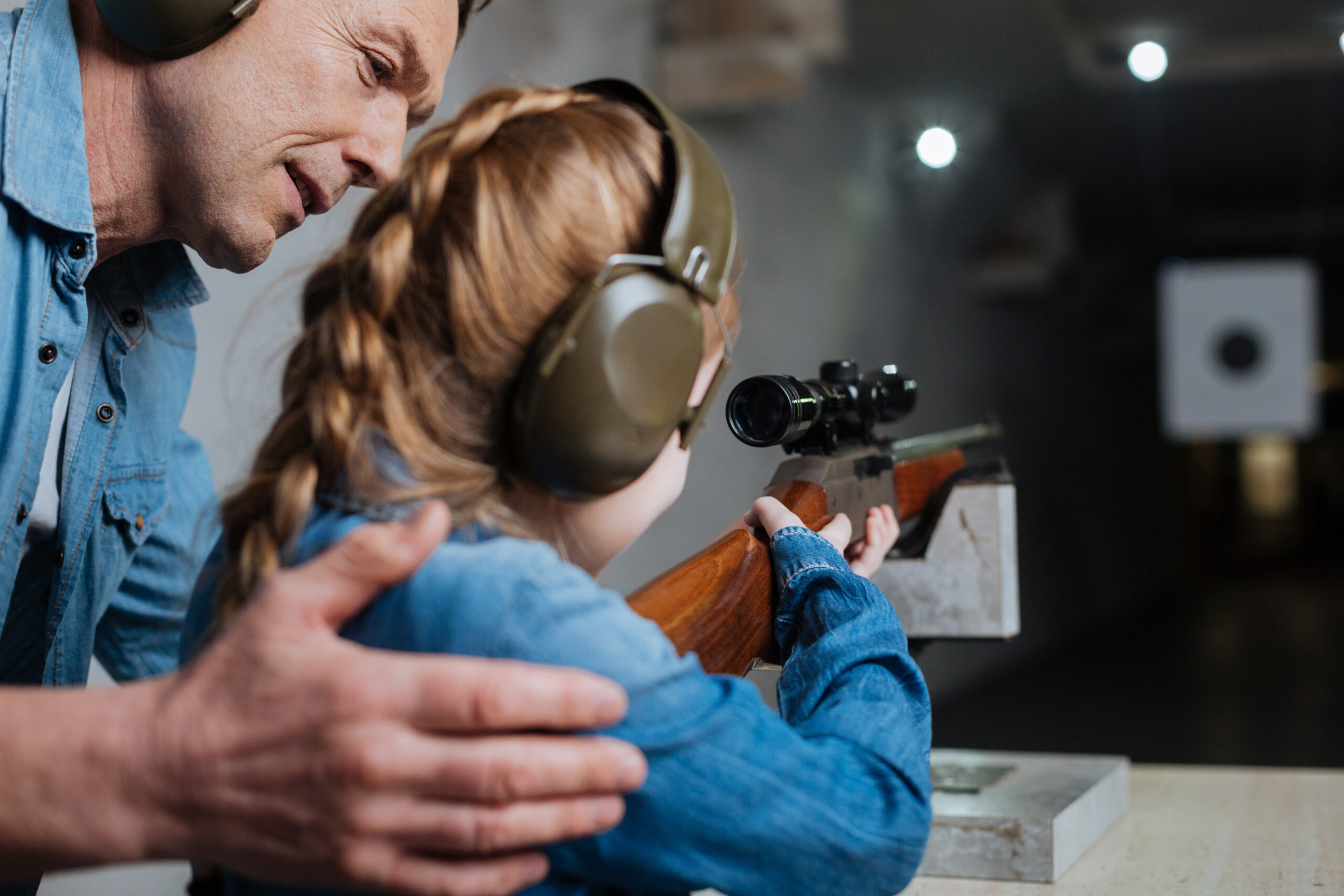 Pleasant,Cheerful,Man,Helping,His,Daughter gun safety, How to Talk to Your Kids About Gun Safety